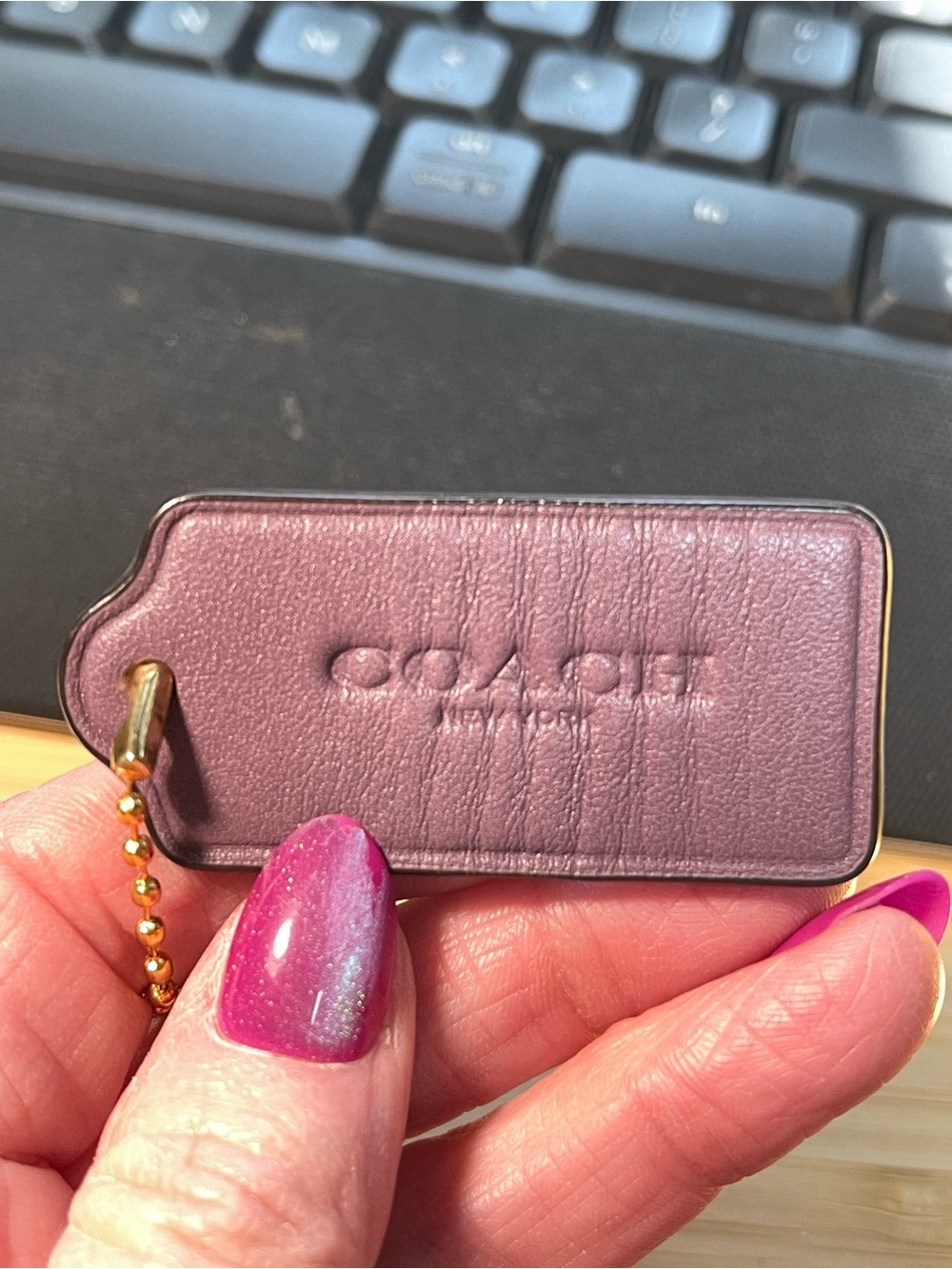 Coach Plum Leather Hang Tag with Gold Chain Accent